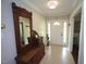 Bright foyer featuring neutral tile, a white front door, and a decorative wood bench at 5112 Stephens Ln, Durham, NC 27712
