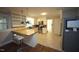 Well-lit kitchen featuring stainless steel appliances, updated lighting, and a breakfast bar at 5112 Stephens Ln, Durham, NC 27712