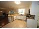Bright kitchen features white cabinets, an island, stainless steel appliances, and tile flooring at 5112 Stephens Ln, Durham, NC 27712