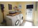 Cozy laundry room equipped with washer, dryer, storage, and ample natural light at 5112 Stephens Ln, Durham, NC 27712