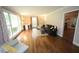 Spacious living room with hardwood floors, large windows, and stylish furnishings at 5112 Stephens Ln, Durham, NC 27712