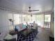 Relaxing sunroom with comfortable seating, ceiling fan and sheer curtains at 5112 Stephens Ln, Durham, NC 27712