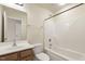 This bathroom features a tub/shower combo, wood cabinets, and updated fixtures at 523 Berry Chase Way, Cary, NC 27519