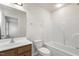 This bathroom features a tub/shower combo, wood cabinets, and updated fixtures at 523 Berry Chase Way, Cary, NC 27519