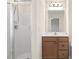 This bathroom features a walk-in shower, wood cabinets, and updated fixtures at 523 Berry Chase Way, Cary, NC 27519