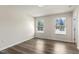 This bedroom features two windows, hardwood floors, and neutral colors at 523 Berry Chase Way, Cary, NC 27519