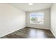 Bright bedroom with hardwood floors and a large window at 523 Berry Chase Way, Cary, NC 27519