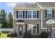 Inviting two-story home with brick facade and well-manicured lawn in a townhome community at 523 Berry Chase Way, Cary, NC 27519