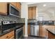 Kitchen with stainless steel appliances and wooden cabinets at 523 Berry Chase Way, Cary, NC 27519