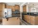 Well-equipped kitchen featuring stainless steel appliances, granite counters and dark wood-look floors at 523 Berry Chase Way, Cary, NC 27519