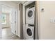 This convenient laundry area has a stacked washer and dryer and neutral colors at 523 Berry Chase Way, Cary, NC 27519