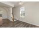 Living room with stairs and a window at 523 Berry Chase Way, Cary, NC 27519