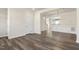 Open living space with dark wood-look floors, white trim and accents throughout the space at 523 Berry Chase Way, Cary, NC 27519