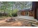 Inviting backyard with a stone fire pit, wooden deck, and built-in bench seating, perfect for outdoor entertaining at 5315 Mccormick Rd, Durham, NC 27713