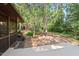 Wood deck and firepit with views of treelined backyard at 5315 Mccormick Rd, Durham, NC 27713