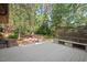 Wood backyard deck featuring a firepit and treelined backyard at 5315 Mccormick Rd, Durham, NC 27713