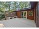View of the backyard deck with lattice and treelined yard at 5315 Mccormick Rd, Durham, NC 27713