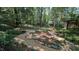 Beautiful backyard featuring tranquil landscaping, mature trees, and custom gravel paths at 5315 Mccormick Rd, Durham, NC 27713