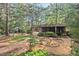 Lush backyard with screened porch, custom benches, and serene landscaping at 5315 Mccormick Rd, Durham, NC 27713