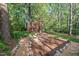 Landscaped backyard with walking path, stone borders, and birdbath at 5315 Mccormick Rd, Durham, NC 27713