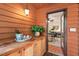 Wet bar area with wood cabinets on the screened porch, perfect for entertaining at 5315 Mccormick Rd, Durham, NC 27713