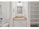 Bright bathroom featuring granite countertop, a tub with shower, and an open shelved closet at 5315 Mccormick Rd, Durham, NC 27713
