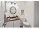 Half bathroom featuring a vanity with a granite countertop, commode, and linen closet at 5315 Mccormick Rd, Durham, NC 27713