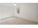 Bright bedroom features neutral carpet, crown molding, and a sunlit window at 5315 Mccormick Rd, Durham, NC 27713