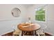 Dining area with wood floors and a view to the outdoors through a large window at 5315 Mccormick Rd, Durham, NC 27713