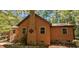 Charming single-Gathering home featuring wood siding, a brick chimney, and surrounded by mature trees at 5315 Mccormick Rd, Durham, NC 27713