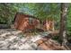 Exterior of the home featuring a walkway, front garden, driveway, and wooded surroundings at 5315 Mccormick Rd, Durham, NC 27713