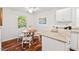 An eat-in kitchen featuring a dining table, white cabinets, and granite countertops at 5315 Mccormick Rd, Durham, NC 27713