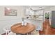 Kitchen and breakfast nook area featuring wood floors, white cabinets, and granite countertops at 5315 Mccormick Rd, Durham, NC 27713