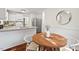 Kitchen and breakfast nook featuring wood floors, stainless steel appliances, and white cabinets at 5315 Mccormick Rd, Durham, NC 27713