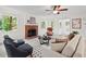Elegant living room featuring a brick fireplace, multiple windows, and tasteful decor at 5315 Mccormick Rd, Durham, NC 27713