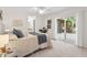 Serene main bedroom with plush carpeting, light neutral walls, and sliding glass doors to a private outdoor space at 5315 Mccormick Rd, Durham, NC 27713