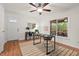 Bright home office featuring hardwood floors, modern desk, storage shelves, and access to the screened porch at 5315 Mccormick Rd, Durham, NC 27713