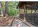 Screened porch exterior with stone pathway and mature trees, ideal for outdoor dining and relaxation at 5315 Mccormick Rd, Durham, NC 27713