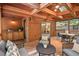 Spacious screened porch with seating and dining areas, bar area, and wooded views at 5315 Mccormick Rd, Durham, NC 27713