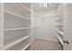 Walk-in closet with carpet floor and many shelves at 5315 Mccormick Rd, Durham, NC 27713