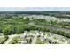 Aerial view of a residential neighborhood with mature trees, a beautiful lake, and well-maintained lawns at 553 Lake Gaston Dr, Fuquay Varina, NC 27526