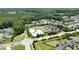 An aerial view showcases the community pool, clubhouse, and surrounding homes nestled within lush greenery at 553 Lake Gaston Dr, Fuquay Varina, NC 27526