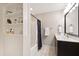 The bathroom features a tub/shower combo and storage shelves for toiletries and decor at 553 Lake Gaston Dr, Fuquay Varina, NC 27526