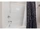 Clean white bathroom with a shower and tub combination and a decorative shower curtain at 553 Lake Gaston Dr, Fuquay Varina, NC 27526