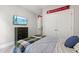 Bedroom with full bed, tv on wall, closet, dresser, and adjacent doorway at 553 Lake Gaston Dr, Fuquay Varina, NC 27526