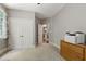 Carpeted bedroom with a closet, open doorway, and small desk area on the right at 553 Lake Gaston Dr, Fuquay Varina, NC 27526