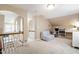Light-filled bonus room boasts neutral carpet, vaulted ceiling, and arched doorway to overlook, creating a versatile space at 553 Lake Gaston Dr, Fuquay Varina, NC 27526