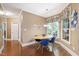 Breakfast nook with natural light from large window, wood flooring, and stylish blue chairs at 553 Lake Gaston Dr, Fuquay Varina, NC 27526