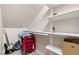 Attic storage space with clothes rack, shelves, personal items and a carpeted floor at 553 Lake Gaston Dr, Fuquay Varina, NC 27526
