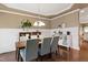 Dining room featuring hardwood floors, modern lighting, and wainscoting at 553 Lake Gaston Dr, Fuquay Varina, NC 27526